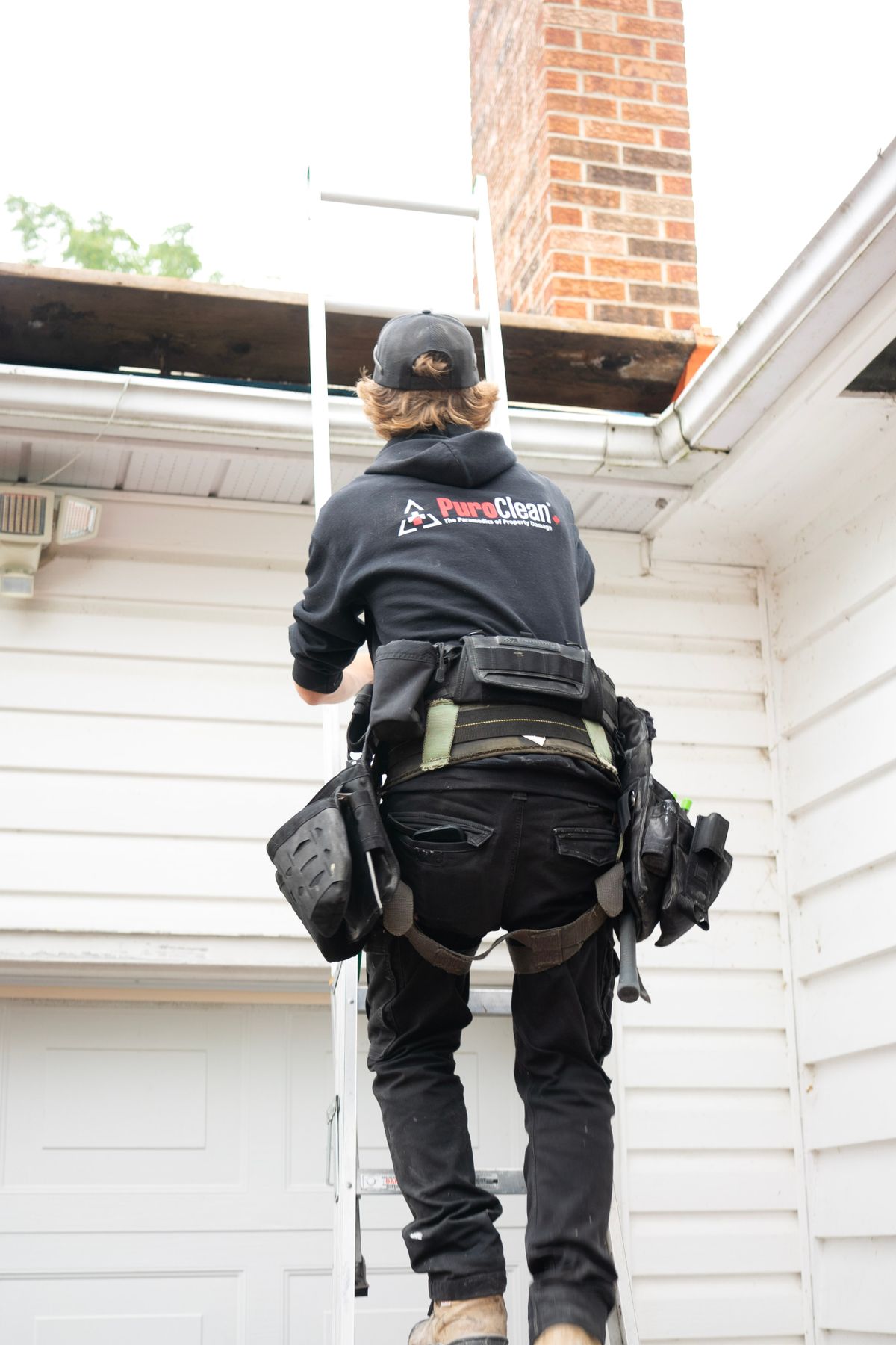 A professional preparing for a roof inspection